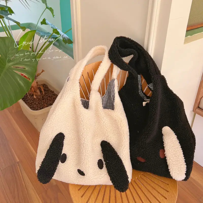 a panda bear bag sitting on top of a wooden table