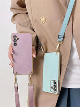 Pastel-colored smartphone cases with attached straps for carrying.