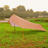 a pink kite is sitting on the ground