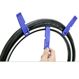 a hand holding a tire tire with two blue handles