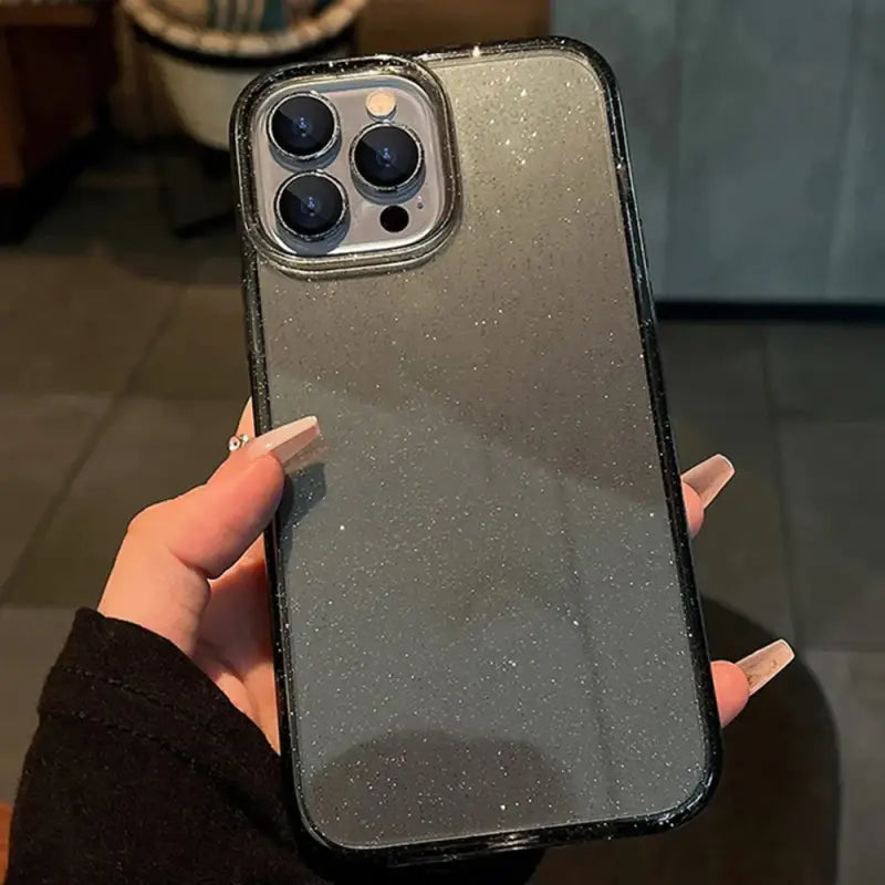 a person holding a black iphone case