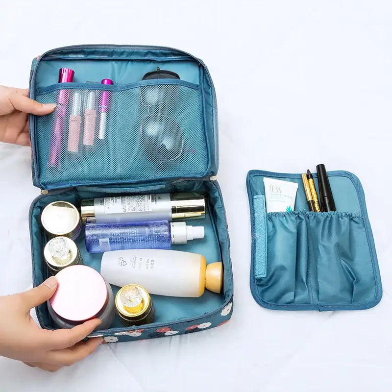 a person holding a blue bag with cosmetics and makeup products