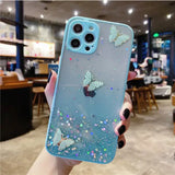 a person holding a blue case with glitter butterflies on it