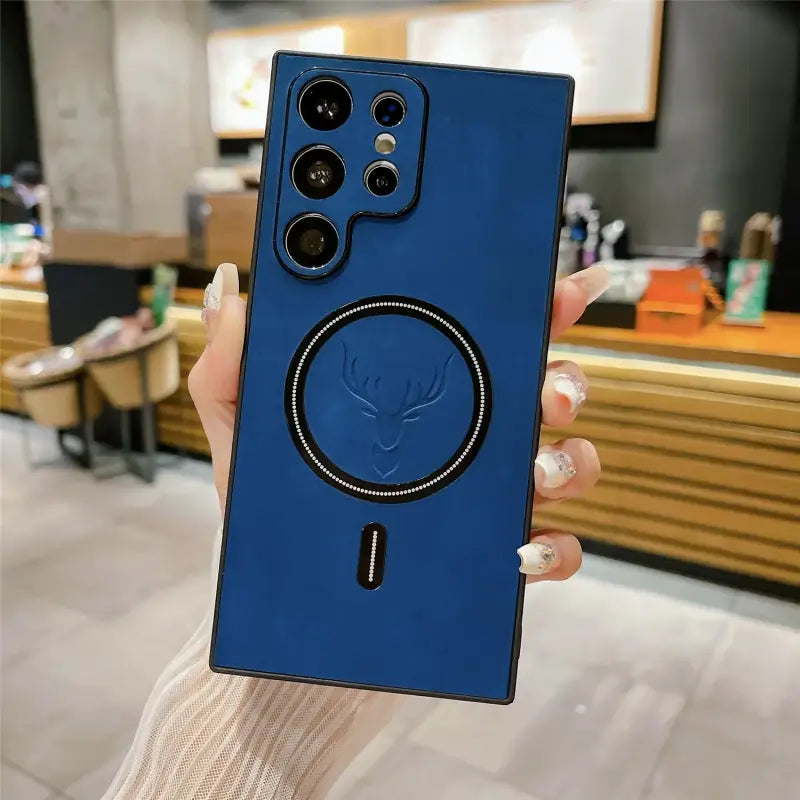 a person holding up a blue phone case