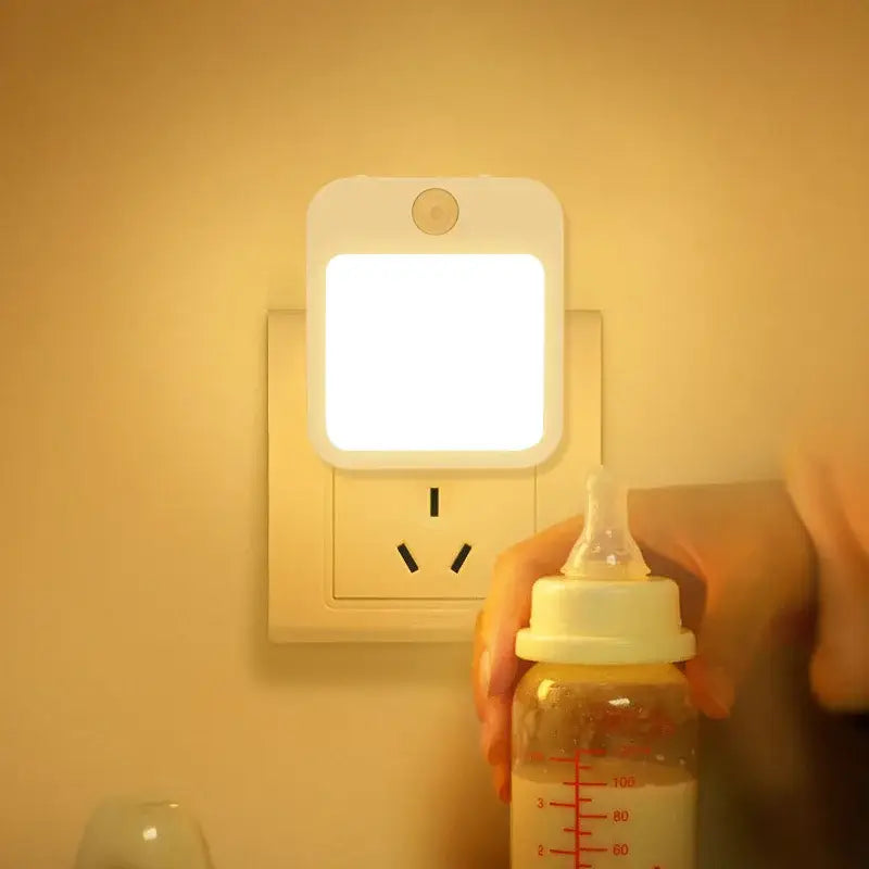 A person is holding a bottle and a light