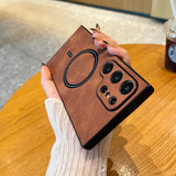 a person holding a brown leather case with a camera