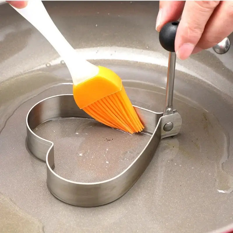 a person using a brush to clean a pan