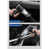 a person using a car vacuum cleaner to clean the interior of a car