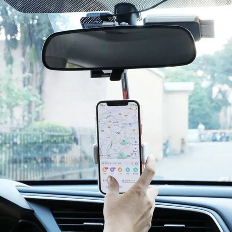 A person holding a cell phone in their car