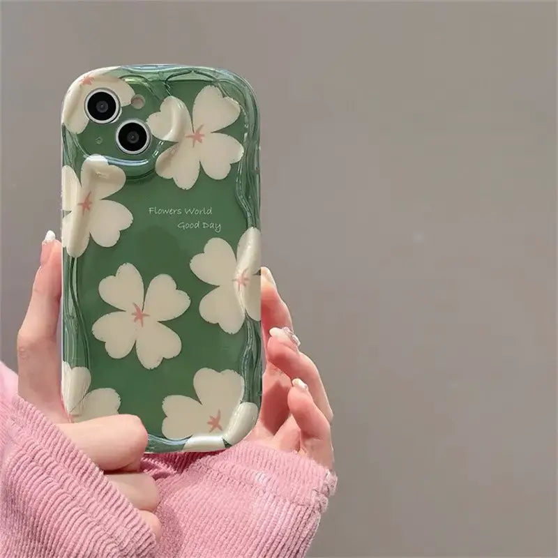 a person holding a cell phone with a flower design on it