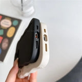 a person holding a cell phone in their hand