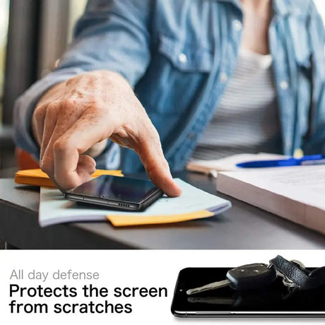 a person using a cell phone on a desk