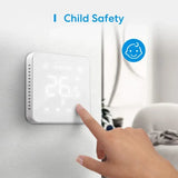 A person touching a child safety button on a wall