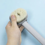 a person using a brush to clean a blue surface