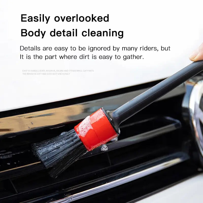 a person is cleaning a car with a brush