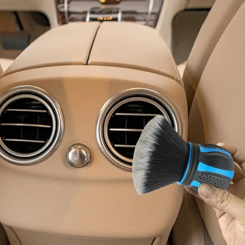 a person cleaning a car with a brush