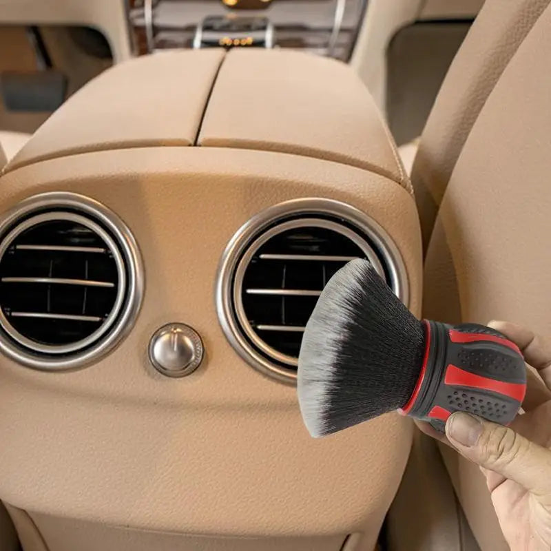 a person cleaning a car with a brush