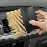 a person cleaning a car with a brush