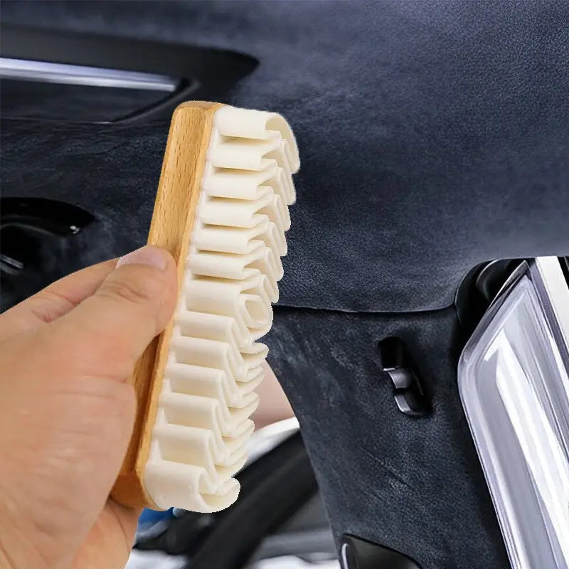 a person cleaning a car with a brush