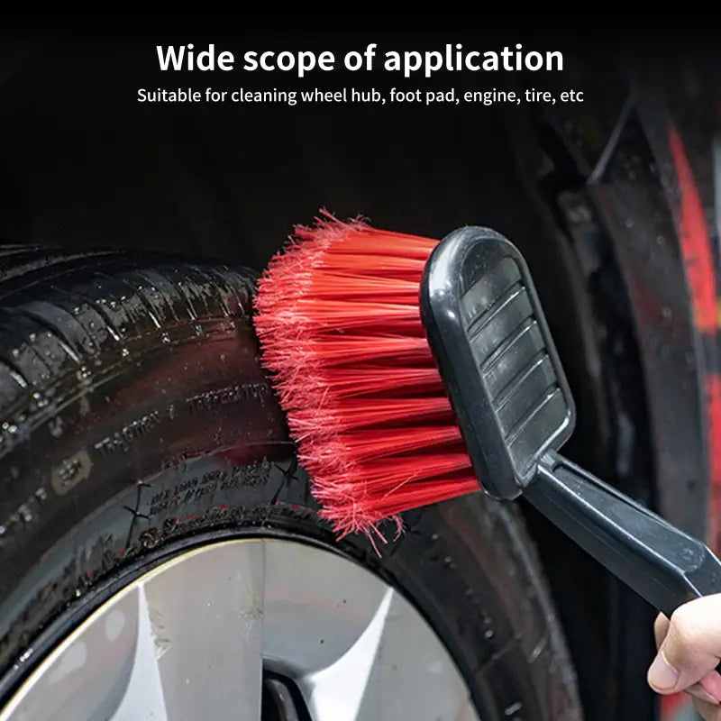 a person cleaning a car with a brush