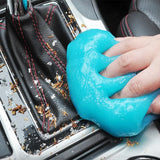 a person is cleaning a car with a blue sponge