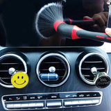 a person cleaning a car with a brush