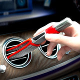 a person cleaning a car dashboard with a brush