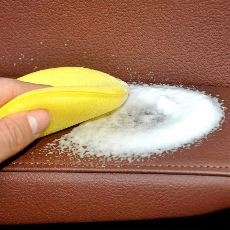 a person cleaning a leather with a sponge