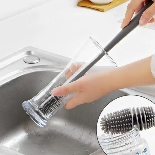 a person is cleaning a sink with a brush