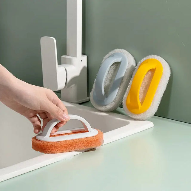 a person cleaning a white sink with a sponge