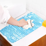 a person cleaning a sink with a sponge