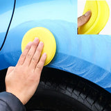 a person cleaning a car with a sponge