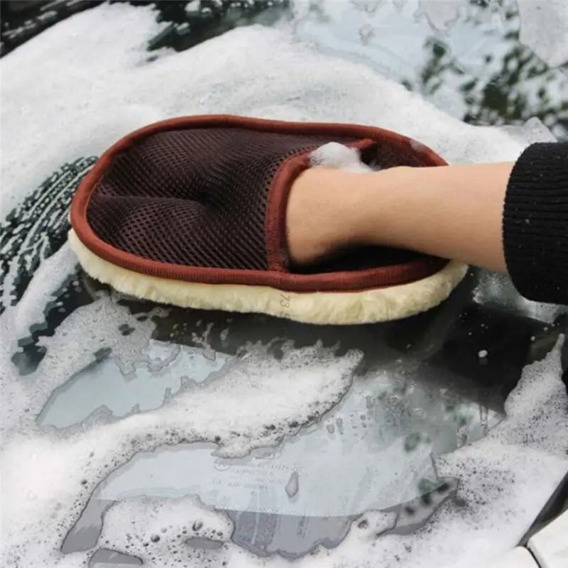 someone cleaning a car with a sponge