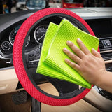 a close up of a person cleaning a car steering wheel