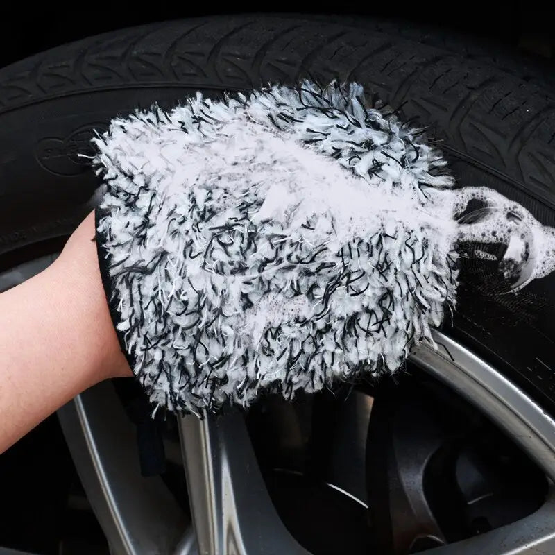 a person cleaning a tire with a rag