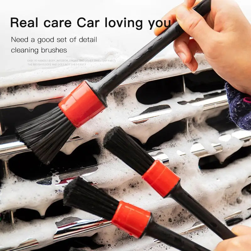 a person holding a brush and cleaning a tray of brushes