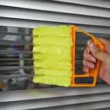 a person cleaning a window with a yellow brush