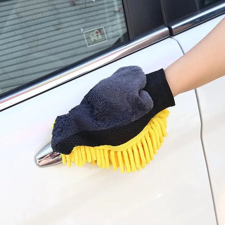 a person cleaning a car with a yellow glove