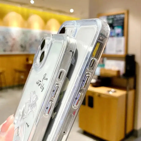 A person holding a clear case with a phone in it