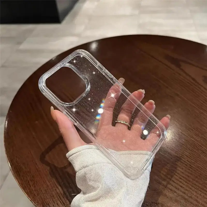 a person holding a clear phone case
