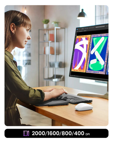 Person working on a computer displaying colorful graphic designs.