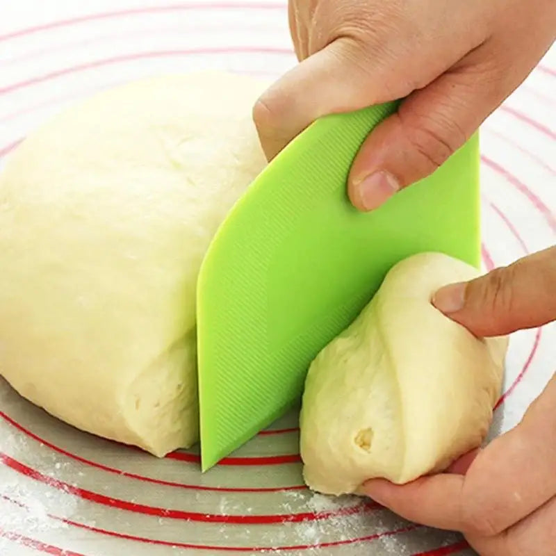 a person cutting a dough into a ball