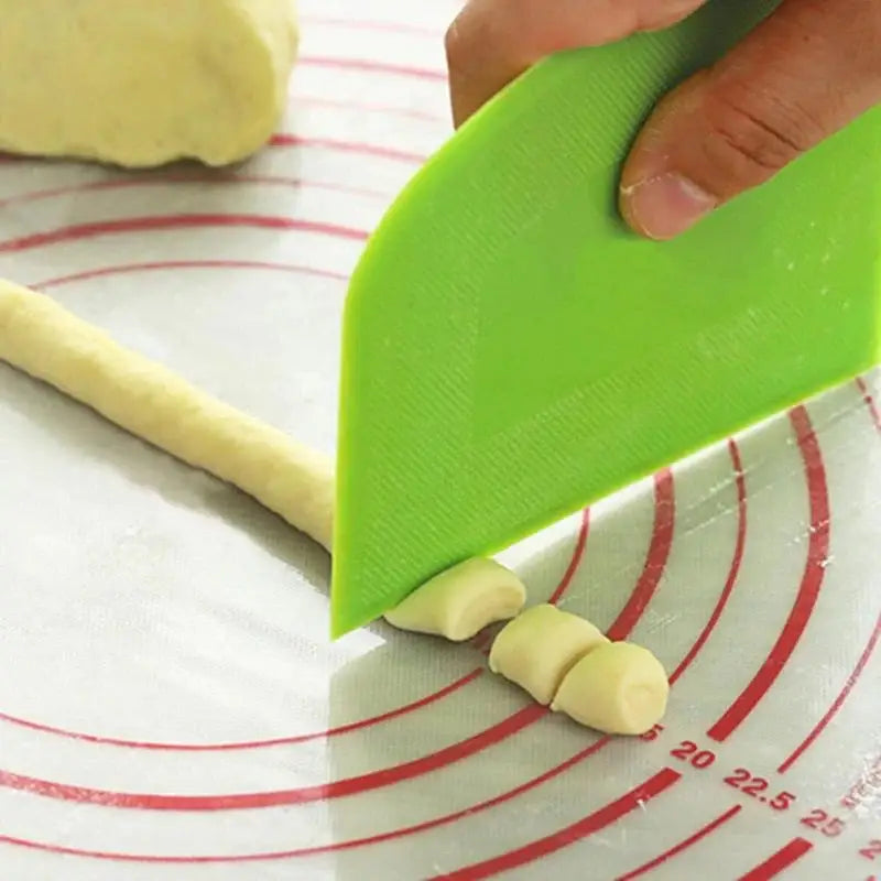 a person cutting dough into a circle