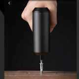 A person using a drill to drill a piece of wood