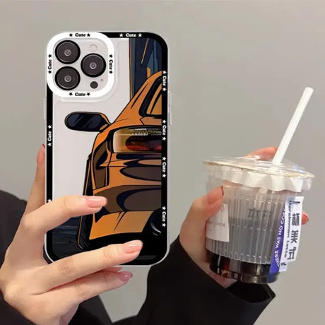 A person holding a drink and a cell case