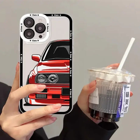 A person holding a drink and a phone case