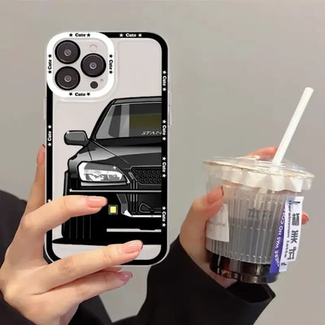 A person holding a drink and a phone case