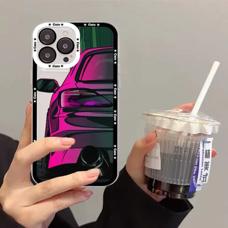 A person holding a drink and a phone case