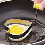 a person is cooking an egg in a pan