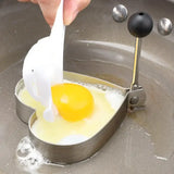 a person is adding an egg into a pan